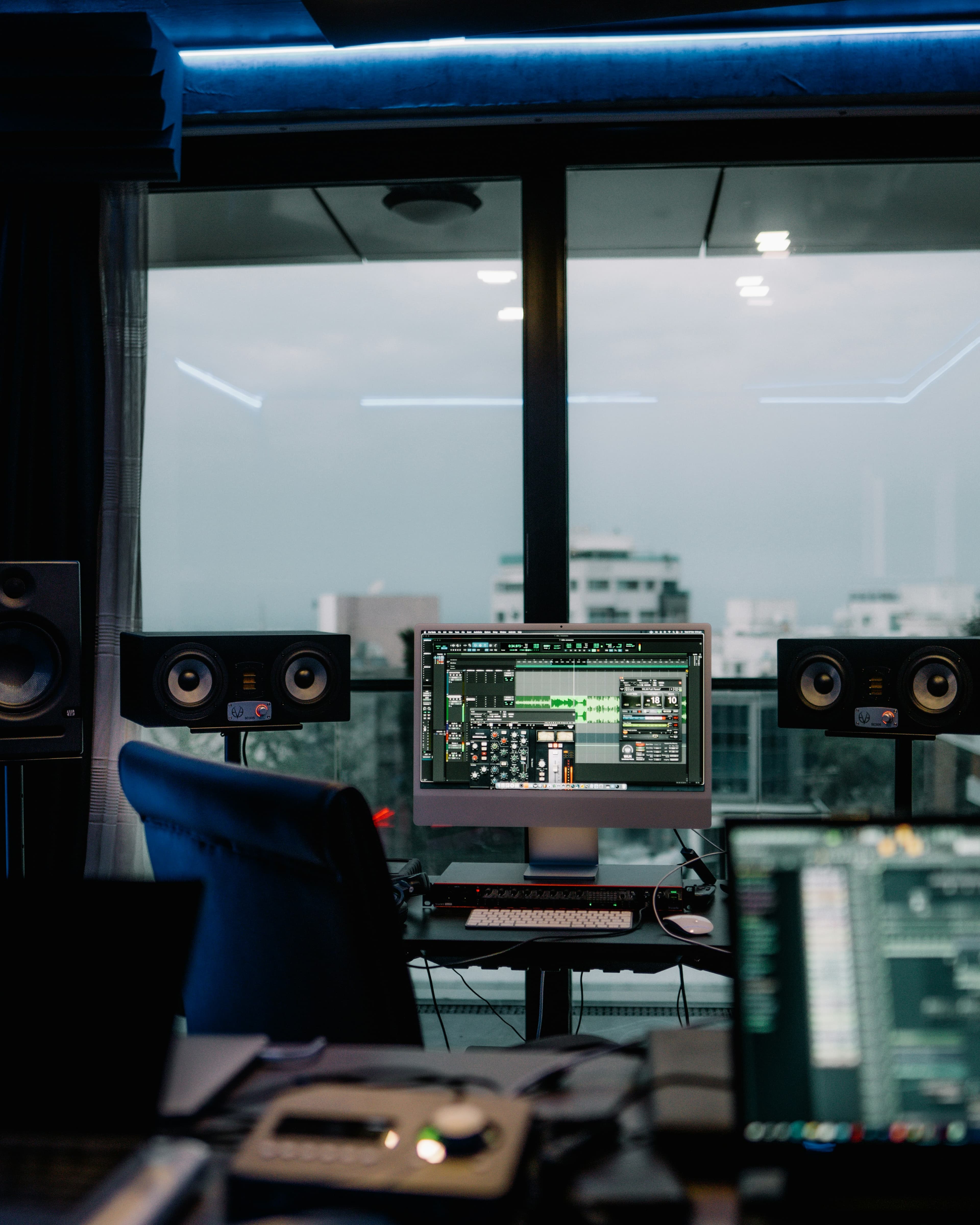 Professional recording studio with mixing console and monitors